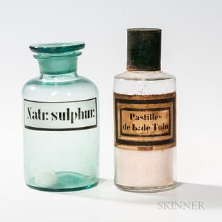 Two Blown Glass Apothecary Jars,an aqua example labeled "Natr. Sulphur.," and a colorless example with painted tin top labeled