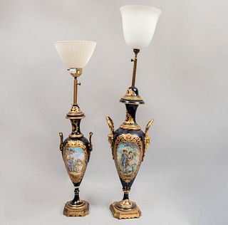 Lote de 2 de lámparas de mesa. Siglo XX. Elaboradas en porcelana tipo Sevres, aplicaciones de metal dorado y pintadas a mano.