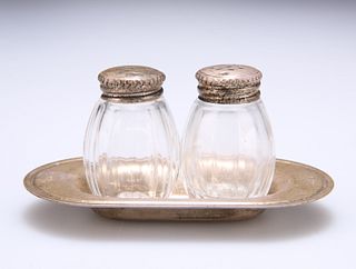 A PAIR OF CHRISTOFLE SILVER-TOPPED SALT AND PEPPER POTS, on