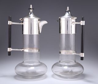 A NEAR PAIR OF SILVER-PLATE MOUNTED CLARET JUGS, IN THE MAN