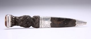 A SCOTTISH SILVER-MOUNTED SGIAN DUBH, unmarked, carved ebon