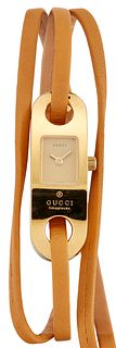 A LADY'S GOLD PLATED GUCCI STRAP WATCH, Model 6100L, with c