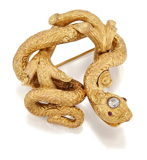 A DIAMOND AND RUBY SNAKE BROOCH, a richly carved snake with
