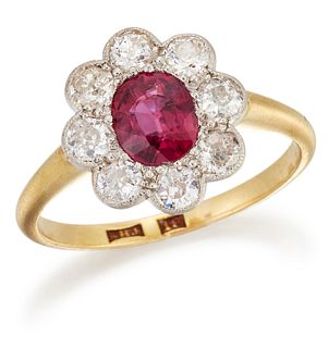 A RUBY AND DIAMOND CLUSTER RING, an cushion-cut ruby within