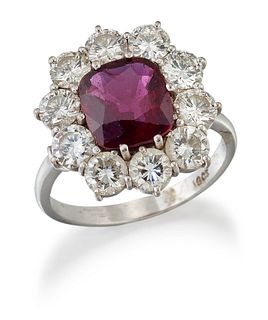A RUBY AND DIAMOND CLUSTER RING, a cushion-cut ruby in a cl