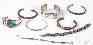 Eight Native American silver and copper bracelets