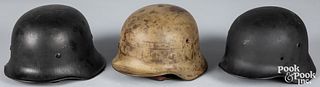 Three German WWII helmets, to include a M40