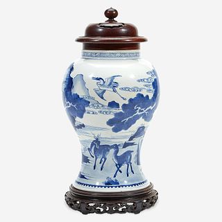 A Chinese blue and white porcelain vase with carved wood cover and stand The vase Kangxi period