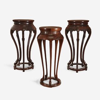 A pair of Chinese hardwood circular stands, together with a similar Chinese carved hardwood circular stand