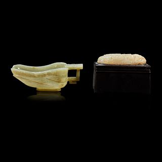 A Chinese celadon jade libation cup, Yi, and a carved grey-white jade oval "Dragon" plaque the jades late Ming to Qing Dynasty