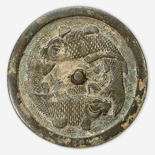 A Chinese bronze "Twin Carp" circular mirror Jin Dynasty (1115-1234)