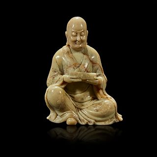 A finely-carved Chinese soapstone figure of a seated luohan