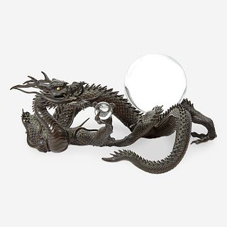 A Japanese patinated bronze dragon and rock crystal sphere Meiji period
