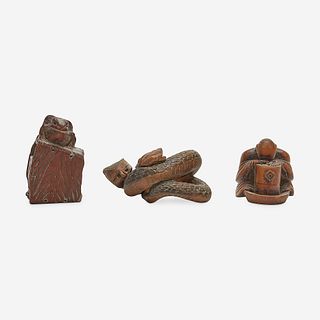 Three Japanese carved wood netsuke: measure and toad, snake and toad, monk and jar