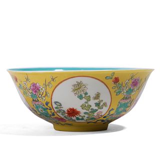 A CHINESE YELLOW-GROUND FAMILLE-ROSE ‘FLORAL' BOWL