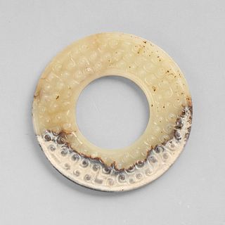 A JADE DISC WITH 'GRAINS' PATTERN