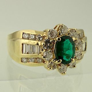Lady's Oval Cut Emerald, Diamond and 14 Karat Yellow Gold Ring.