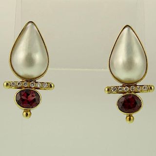 Lady's Mabe Pearl, Oval Cut Garnet, Round Cut Diamond and 14 Karat Yellow Gold Earrings.