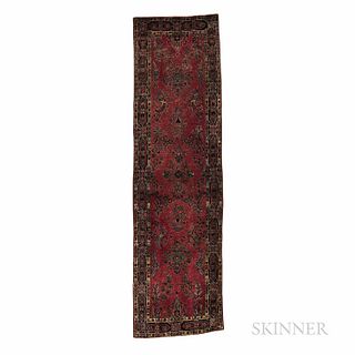 Sarouk Runner, Iran, c. 1920, featuring scattered floral sprays on the burgundy red field, 9 ft. 10 in. x 2 ft. 9 in.