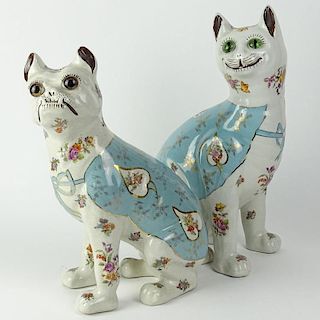 A pair of comical pottery figures of a seated cat and a French bulldog with glass eyes