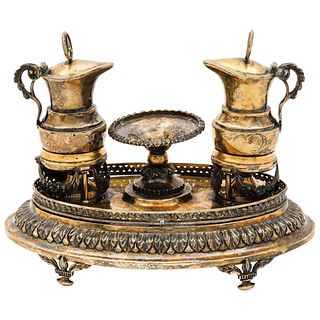 ALTAR CRUETS MEXICO, 19TH CENTURY Gilt silver Oval structure with four lower supports, decorated with vegetal borders 751 g