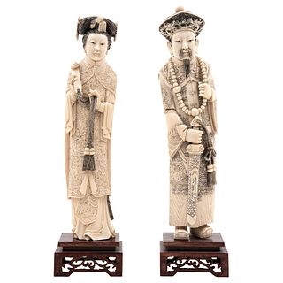 IMPERIAL COUPLE CHINA, 20TH CENTURY Ivory carving with sgraffito and inked motifs; openwork wooden bases 11.8" (30 cm) tall