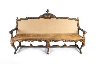 An Italian Early Rococo Parcel-Gilt and Painted Settee
Height 51 x length 72 x depth 24 inches.