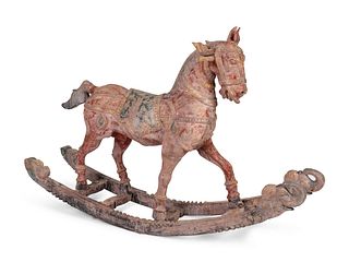 An Indian Polychromed and Carved Wood Rocking Horse
Height 28 x length 45 inches.
