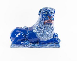 A Luneville Style Blue-Glazed Faience Recumbent Lion
Height 14 1/2 x length 18 x width 9 inches.
