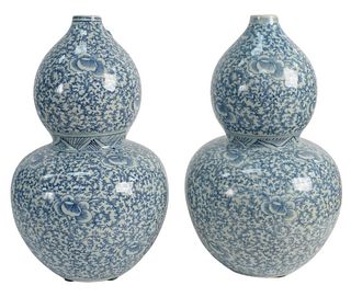 Pair of Blue and White Chinese Double Gourd Vases decorated with flowers and scrolling foliage, height 15 inches. The Estate of Gloria Schiff, 630 Par