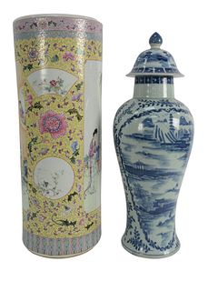 Two Chinese Porcelain Pieces to include a blue and white covered urn, height 23 inches, along with a Famille Rose umbrella stand having painted courty