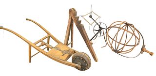 Four Primitive Farming Implements to include an iron yarn winder with adjustable spool and leather strap, a large wooden wool winder, diameter 25 inch