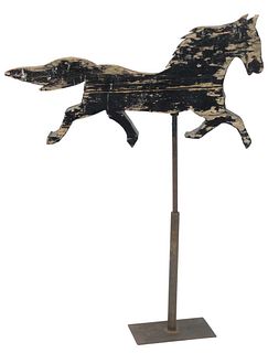 Primitive Wood Horse Weathervane crudely carved in trotting position and painted black, mounted on an iron stand, length 40 inches.