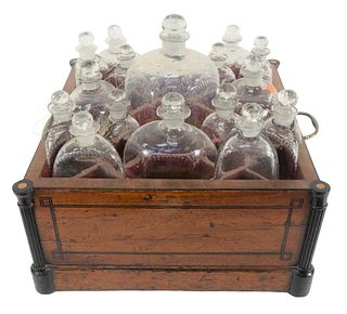 Victorian Tabletop Cellacette having 17 form fitting etched bottles with stoppers in a mahogany inlaid case with handles, 17" x 17", largest bottle he