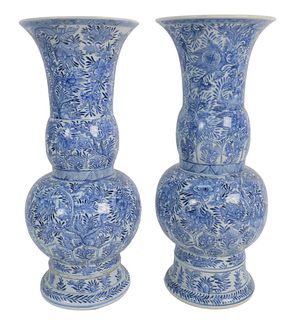 Pair of Chinese Blue and White Yen Yen Vases having flaring rims over slender neck and bulbous body all over foliate design (both repaired), heights 1