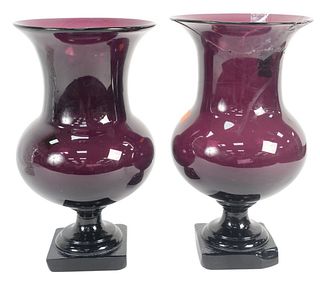 Pair of Amethyst Glass Urns having flared rim and bulbous body on square stem foot, both foot corners ground and one rim heavily repaired, height 11 1