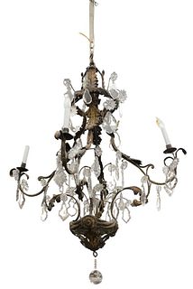 French Rococo Chandelier having four iron arms with metal leaf and crystal prism. Provenance: The Estate of Gloria Schiff, 630 Park Avenue, New York.