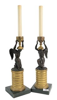 Pair of Bronze Candlesticks having a winged bronze man holding an urn and kneeling on plinth base, total height 23 1/4 inches. Provenance: From a Newp