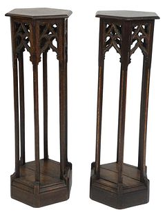 Pair of Gothic Style Oak Pedestals, with six sided top all set on raised platform bases (one in darker finish), height 44 inches, diameter 14 inches.