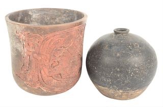 Two Glazed Pottery Vessels, to include black glazed jug with incised decoration, height 5 inches; along with early pot having carved figure on one sid