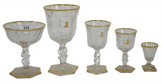 Sixty Three Piece Set of Crystal having gold rim on hexagonal gold rimmed bases and gilt bud cartouche, to include 8 red wine, 18 white wine, 9 sherry