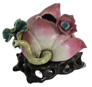 Chinese Lotus Flower Bud Pot, pink bud having worm eaton hole and green leaves on stand, pot height 2 1/4 inches. Provenance: The Estate of Diana Atwo