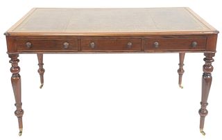 George IV Style Mahogany Partners Writing Table, having tooled leather top over three drawers on either side all on turned legs ending in on brass cas