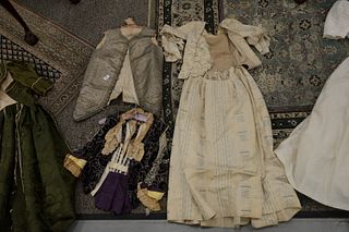 Five piece group of Victorian clothing to include a cut velvet jacket with pearls, two  Victorian dresses, a wedding dress, and a vest with silver thr