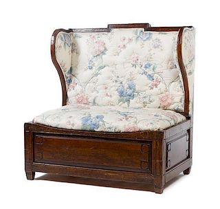 * An English Oak Wingback Settle Height 40 x width 41 1/2 x depth 26 1/2 inches.