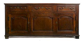 An English Oak Sideboard Height 34 1/4 x width 72 1/4 x depth 20 inches.