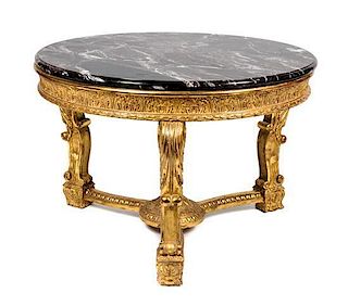 A George II Style Giltwood Center Table Height 32 1/2 x diameter 47 1/2 inches.