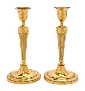 A Pair of George III Brass Candlesticks Height 10 1/2 inches.