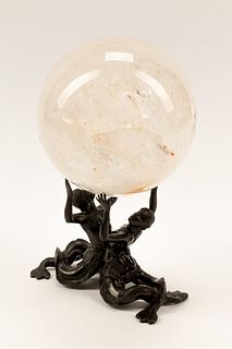 A Rock Crystal Spherical Ornament on a Patinated Bronze Figural Base
Height overall 11 x width 6 inches.