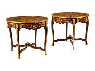 A Pair of Louis XV Style Gilt Bronze Mounted Gueridons with Tiger's Eye Tops
Height 30 x diameter of tops 35 1/2 inches.